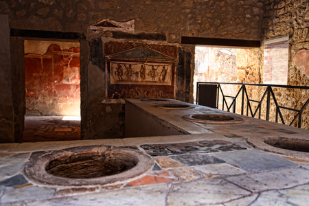 Shop counter in the once buried Roman city of Pompeii south of Naples under the shadow of Mount Vesuviusのeditorial素材