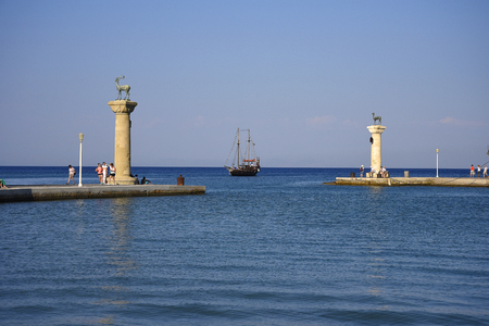 the statues at the entrance to Mandraki Harbour on the island of Rhodesの写真素材