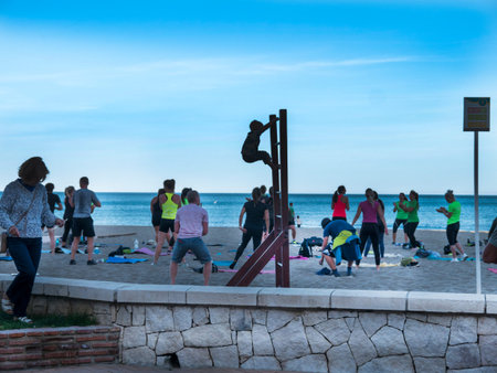 Unidentified people are engaged in fitness on the beach in Fuengirola in Spain