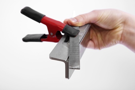 hand holding race ski edge tuning side bevel guide, file and clampの写真素材