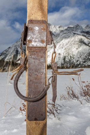 vintage ski bindings closeup with winter scenery in backgroundの写真素材