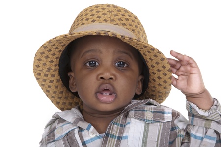 toddler wearing an oversized hat on white backgroundの写真素材