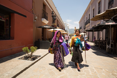 April 14,2014 - Tzotzil women walking in San Cristobal de las Casas, Chiapas dressed in traditional clothing. They sell crafts and traditional merchandise to tourists.のeditorial素材