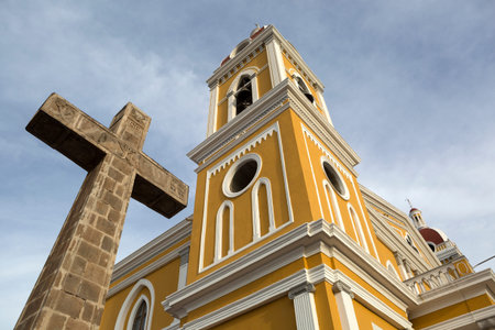a giant stone cross in the front of the Ctahedral de Granada Nicaraguaの写真素材