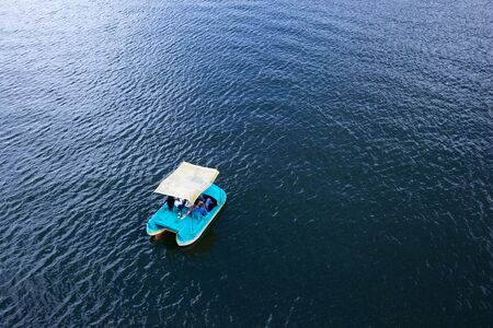 November 13, 2016 Gautape, Colombia: a cople is floating on the water of the artificial lake in a pedal boat during the long weekend of Cartagena Day. The lake is a popular destination for water sports.のeditorial素材