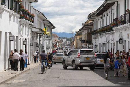 July 6, 2017 Popayan, Colombia:car turns into a narrow street flanked by white wash historic colonial buildingsのeditorial素材