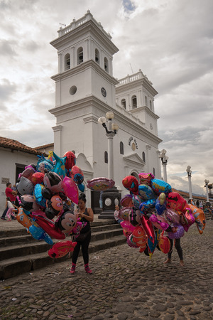 July 23, 2017 Giron, Santander: balloon vendors in the historic town centre in the front of the cathedral on a Sunday afternoonのeditorial素材