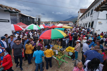 July 15, 2017 Villa de Leyva, Colombia: the large cobblestone plaza is filled up with vendors and visitors during the annual fiestaのeditorial素材