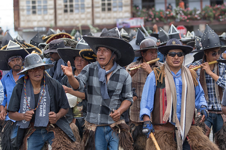 June 24, 2017 Cotacachi, Ecuador: indigenous people dancing in the street during summer solstice celebrationsのeditorial素材
