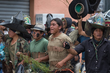June 29, 2017 Cotacachi, Ecuador: kichwa indigenous people with extra large hats and chaps dancing...