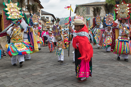 June 18, 2017 Pujili, Ecuador: indigenous kichwa woman dancing in the street wearing a colourful traditional dress at Corpus Christi paradeのeditorial素材