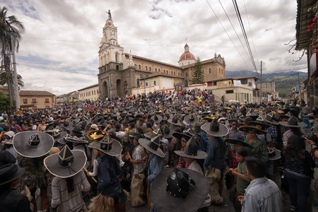June 24, 2017 Cotacachi, Ecuador: crowd of indigenous kichwa men  participating in a parade at summer solsticeのeditorial素材