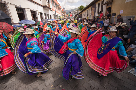 June 17, 2017 Pujili, Ecuador: indigenous women in brigthly colored clothng performing on the street during Corpus Christi paradeのeditorial素材
