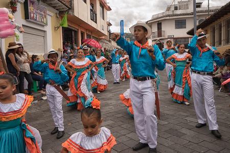 June 17, 2017 Pujili, Ecuador: dancers in brightly colored clothing performing at the Corpus Christi paradeのeditorial素材