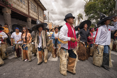 June 24, 2017 Cotacachi, Ecuador:  indigenous kichwa men wearing chaps dancing at the Inti Raymi parade at summer solsticeのeditorial素材