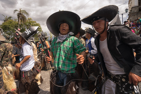 June 24, 2017 Cotacachi, Ecuador: dancing indigenous kichwa men at the Inti Raymi parade at summer solsticeのeditorial素材