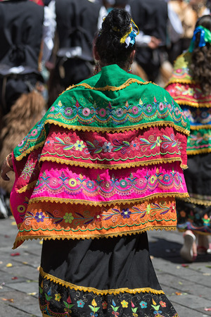 June 17, 2017 Pujili, Ecuador: colourful dress of an indigenous woman in the Corpus Christi paradeのeditorial素材