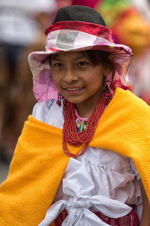 June 17, 2017 Pujili, Ecuador: young indigenous girl in bright color traditional clothing at Corpus Christi parade dancing in the streetのeditorial素材