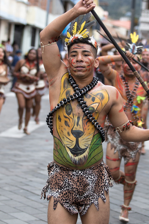 June 17, 2017 Pujili, Ecuador: male dancer from he Amazon area at the Corpus Christi annual paradeのeditorial素材