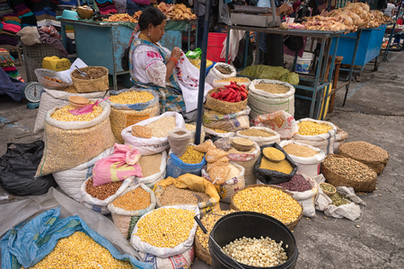 May 6, 2017 Otavalo, Ecuador: produce vendor in the Saturday market selling from street levelのeditorial素材