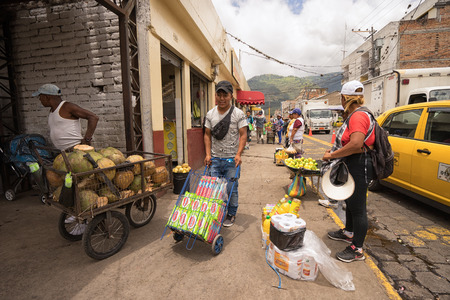 April 6, 2017 Ibarra, Ecuador: street vendors selling produce on the sidewalkのeditorial素材