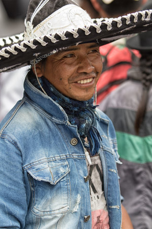 June 24, 2017 Cotacachi, Ecuador: man using conch shell to make noise at the Inti Raymi parade
