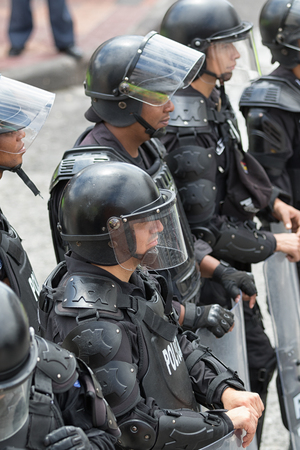 June 24, 2017 Cotacachi, Ecuador:  riot police with shields standing on the side of the street during the Inti Raymi paradeのeditorial素材