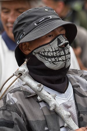 June 24, 2017 Cotacachi, Ecuador:closeup of an indigenous quechua man wearing face mask at the Inti Raymi paradeのeditorial素材