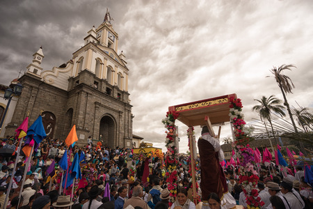 April 14, 2017 Cotacachi,Ecuador: people surrounding a religious float in the front of the church during Easter processionのeditorial素材