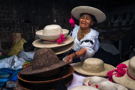 April 21, 2017 Iluman, Ecuador: quechua woman presenting a variety of traditional felt hats her shops producesのeditorial素材