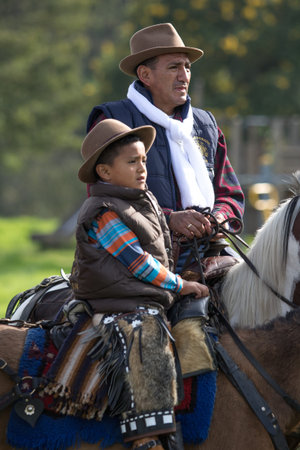 May 27, 2017 Sangolqui, Ecuador: two generations of cowboys in saddle at a rural rodeo in the ndesのeditorial素材