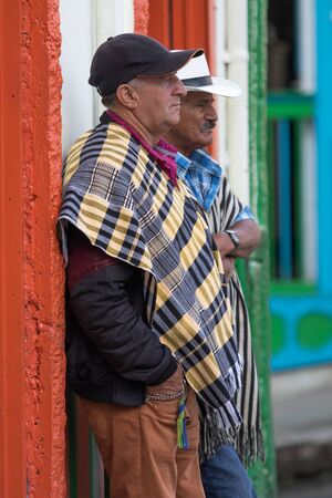 February 20, 2017 Salento, Colombia: local farmers dressed in poncho standing in the streetのeditorial素材