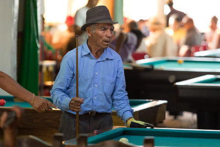 February 20, 2017 Salento, Colombia: man playing pool in  a bar in the coffee region town