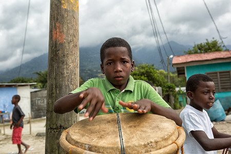 March 8, 2015 Sambo Creek, Honduras: young garifuna boy playing a traditional drumのeditorial素材