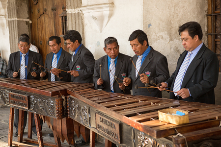 February 8, 2015 Antigua, Guatemala: men marimba band playing in front of a colonial buildingのeditorial素材