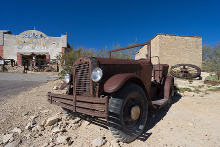 December 14, 2015 Terlingua, Texas: car wreck in front of , the Chisos Movie Theater constructed in the 1930âs, nowadays functioning as a restaurant for tourists visiting the ghost townのeditorial素材