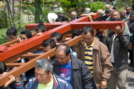 men carrying a cross at Easter in San Pedro la Laguna