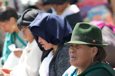 Otavalo, Ecuador-December 23, 2017: indigenous people sitting outdoors in the local marketのeditorial素材