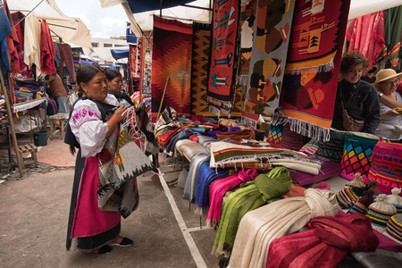 Otavalo, Ecuador - January 13, 2018: the artisan market in Plaza de Ponchos is very popular with touristsのeditorial素材