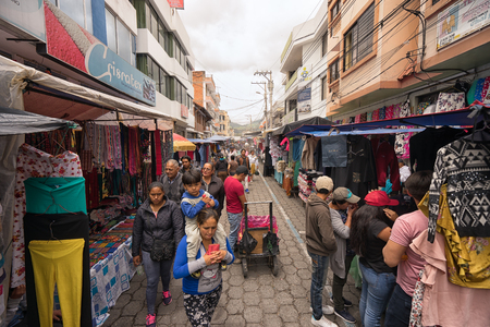 Otavalo, Ecuador-March 31,2018: people walk between the vendor stands set up on the street on market dayのeditorial素材