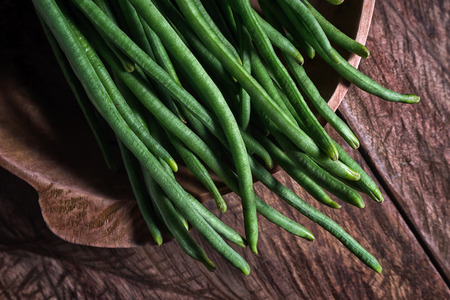 chinese yard-long green beans closeup in a wooden bowlの写真素材