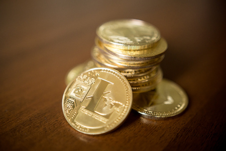 Business concept of crypto currency. Golden Lightcoin on us dollars close up.の写真素材