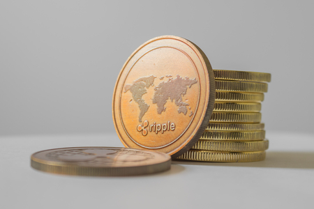 Ripple (XRP) and cryptocurrency investing concept - Physical metal Ripple coins with white background.の写真素材