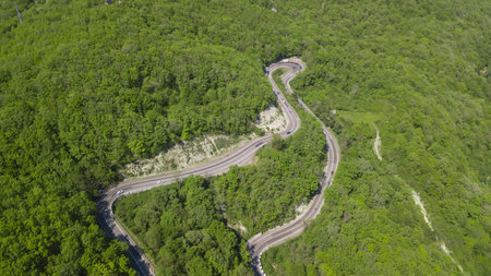 Top view. Aerial view from drone. Road in forest is beautiful with many tree, road on pass very...