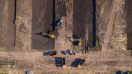 Aerial construction view of long arm excavator working on the fieldの写真素材