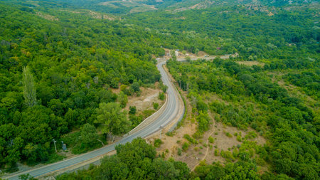 Crimean roads: aerial view of curvy mountain road in summer day