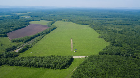 Aerial landscape nature - Dense green forest, green meadows, blue sky in southern Russiaの写真素材
