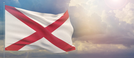 Flags of the states of USA. State of Alabama flag. Waving flag on sunset sky background 3D...