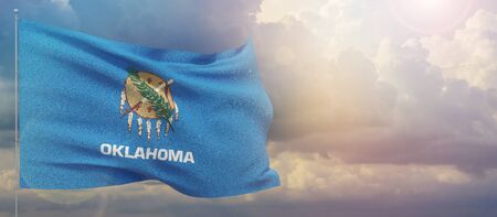 Flags of the states of USA. State of Oklahoma flag. Waving flag on sunset sky background 3D illustration.の写真素材