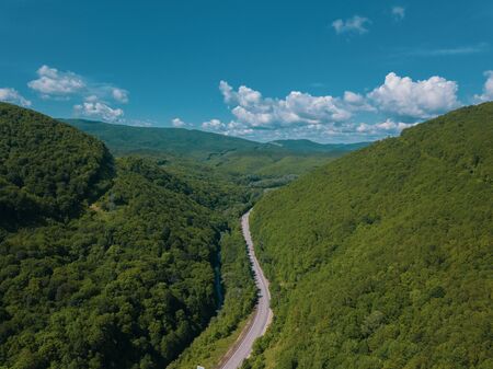 Aerial view of a rural highway between mountainsの写真素材